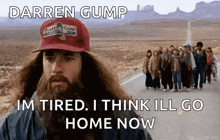 a man with a beard is wearing a darren gump hat while a group of people walk down a road .