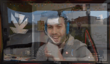 a man wearing headphones is smiling in front of a screen that says volvo