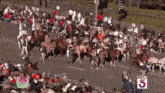 a crowd of people watching a parade with a ktla 5 sign
