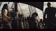 a group of pirates are standing on a ship looking at something