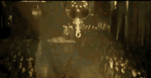 a large key is hanging from the ceiling above a crowd