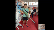 a man is holding a rifle in front of a sign that says atomico