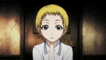a young girl with blonde hair and blue eyes holds her hand to her mouth
