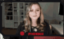 a woman is standing in front of a screen that says phoenix