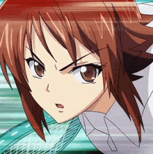 a close up of a girl 's face with red hair and brown eyes
