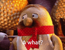 a stuffed animal with a red scarf around his neck and the words a what on it