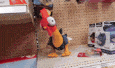 a stuffed chicken is on a shelf next to a box that says ' magician ' on it