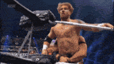 a man in a wrestling ring with the word aew in the corner
