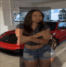 a woman stands in front of a red sports car