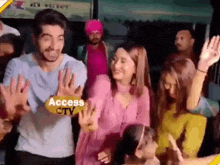 a group of people are dancing in a room with a man holding a sign that says access ctv .