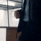 a man in a suit is holding a book