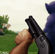 a person is holding a shotgun in their hand