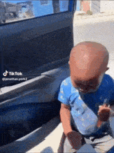 a baby is crying while sitting in the back seat of a car