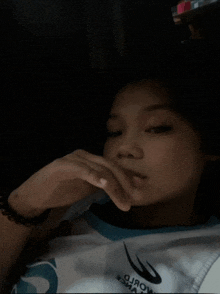 a young girl wearing a shirt that says world on it