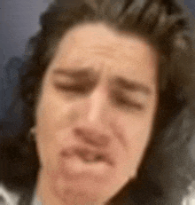 a close up of a man making a funny face .