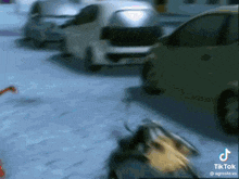 a blurred image of cars parked in a parking lot