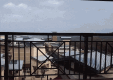 a view of a city from a balcony with a railing