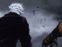 a man with white hair and a black jacket is walking in the rain
