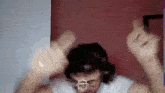 a man wearing headphones is giving the middle finger in a video