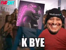 a man wearing a multiverse hat is holding a poster of a monster