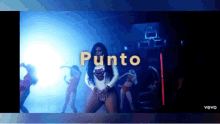 a video of a woman dancing with the word punto on the screen