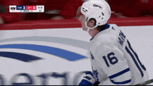 a hockey player with the number 16 on his jersey looks to his left