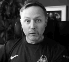 a black and white photo of a man wearing headphones and a shirt that has the number 9 on it