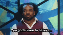 a man says " you gotta learn to believe " in front of a colorful background