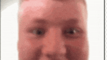 a close up of a man 's face with a white background and red eyes .