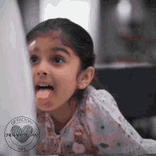a little girl sticking her tongue out with a gif factory logo in the corner