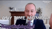 a man in a suit and tie is talking into a microphone and says any time momma . happy birthday ben !