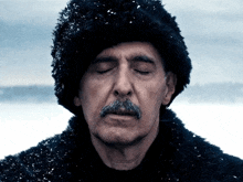 a man with a mustache wearing a fur hat and a fur coat with his eyes closed
