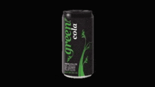 a black can of green cola with a green label on a black background