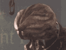 a close up of a person 's head with a hook on it