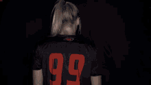 a woman wearing a campbell jersey with her arms crossed