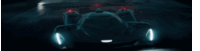 a futuristic race car is driving down a dark road at night .