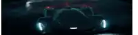 a futuristic race car is driving down a dark road at night .