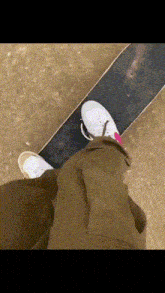 a person standing on a skateboard with their feet on it