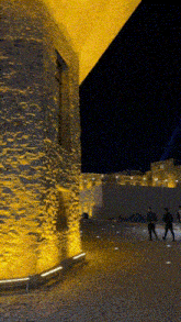 a building with a yellow light on the side of it