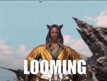 a video game character is standing in front of a mountain and the word looming is visible