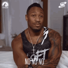 a man wearing a tank top that says " the off " on it