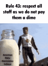 a man standing next to a bottle of milk that says american dairy association indiana on it
