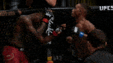two men in a boxing ring with ufc written on the side