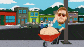 a man in a fbi shirt pushes a wheelbarrow full of sand