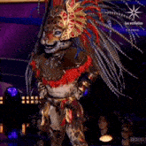 a person dressed in a leopard costume with feathers