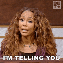 a woman with curly hair says " i 'm telling you " in front of a be tv logo