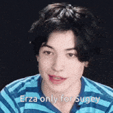 a young man wearing a blue and white striped shirt with the words erza only for sugey written on it .