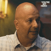 a bald man with the words you 're my hero on the bottom