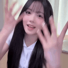 a girl with long black hair is making a funny face with her hands outstretched