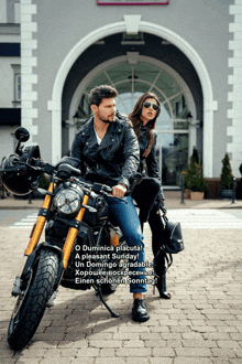a man is sitting on a motorcycle with a woman standing next to him in front of a building
